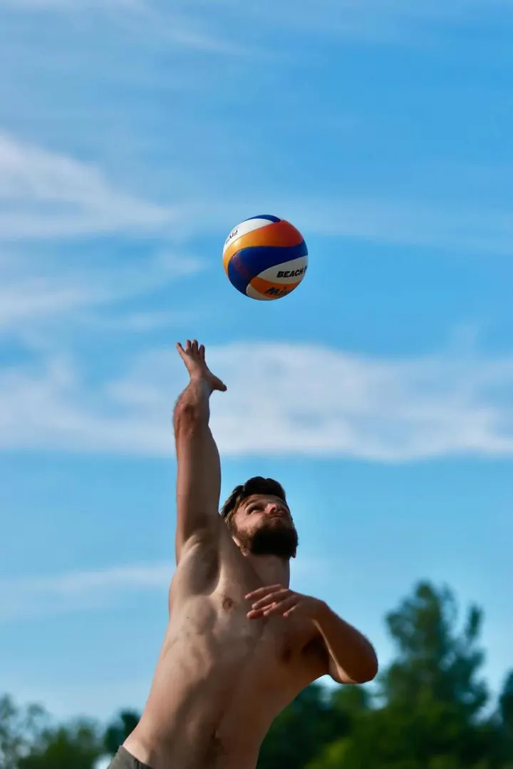 Alain Pineault reaching for a jump serve on the beach
